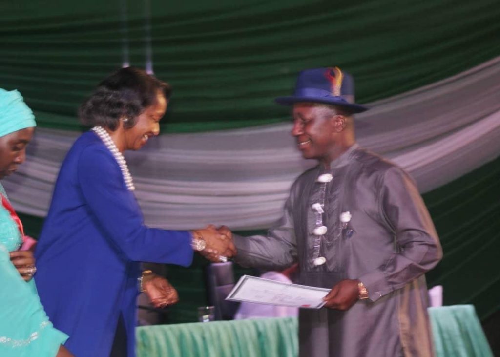 Professor Steve Azaiki receives certificate of return from Mrs Oluwatoyin Babalola Director Legal Services INEC